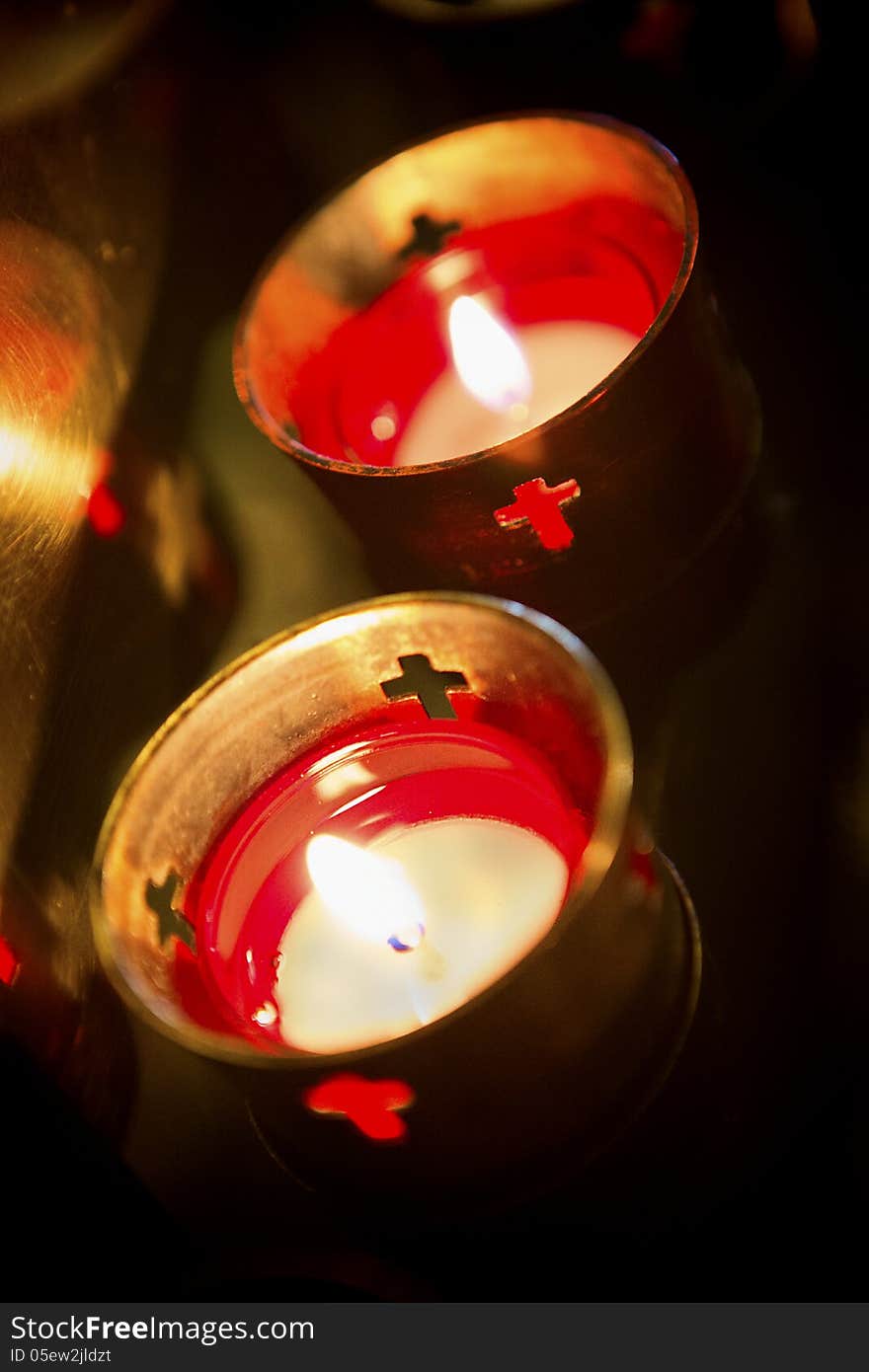 Devotional candles lighting a darkened Basilica of the National Shrine of Mary, Queen of the Universe. Devotional candles lighting a darkened Basilica of the National Shrine of Mary, Queen of the Universe.