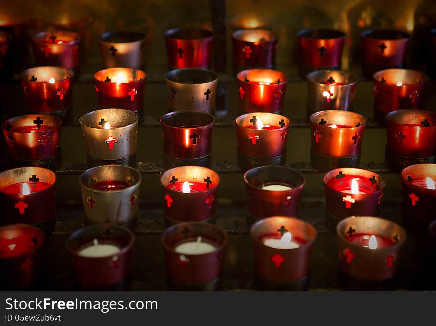 Devotional candles lighting a darkened Basilica of the National Shrine of Mary, Queen of the Universe. Devotional candles lighting a darkened Basilica of the National Shrine of Mary, Queen of the Universe.