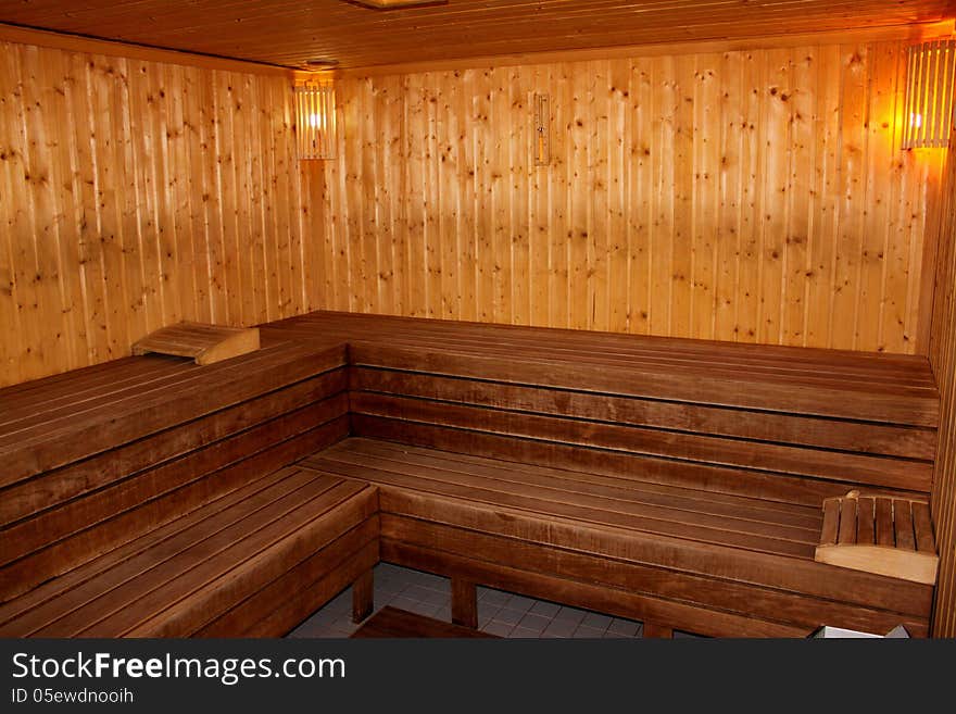 Finnish sauna interior lighted with wooden bench