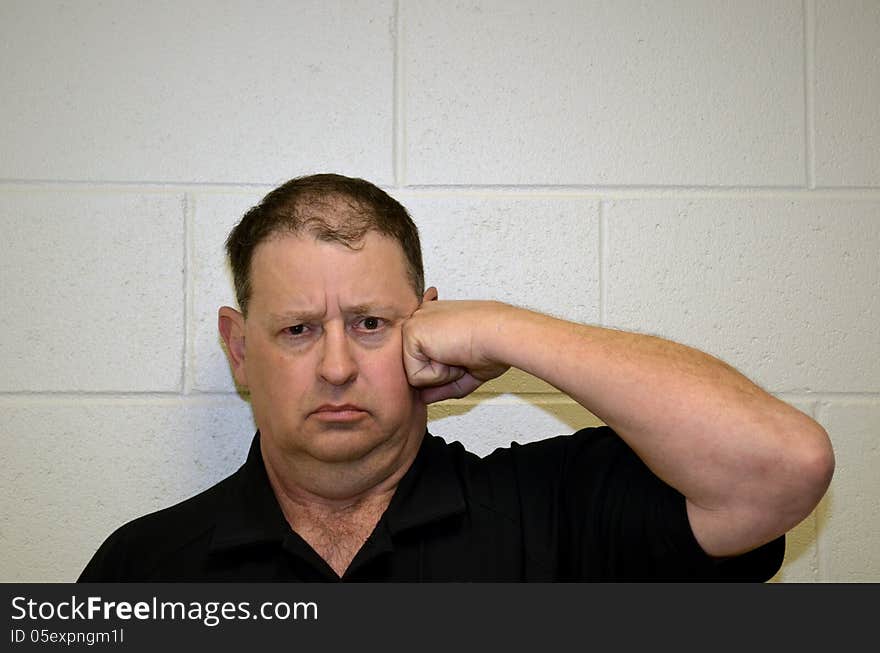 Angry man hitting himself in the head with his fist