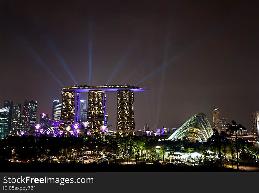 SINGAPORE - APRIL 14 : Laser show of Singapore Marina Bay Sand and Garden by The Bay from Marina Barrage on April 14, 2013, Singapore City. Singapore