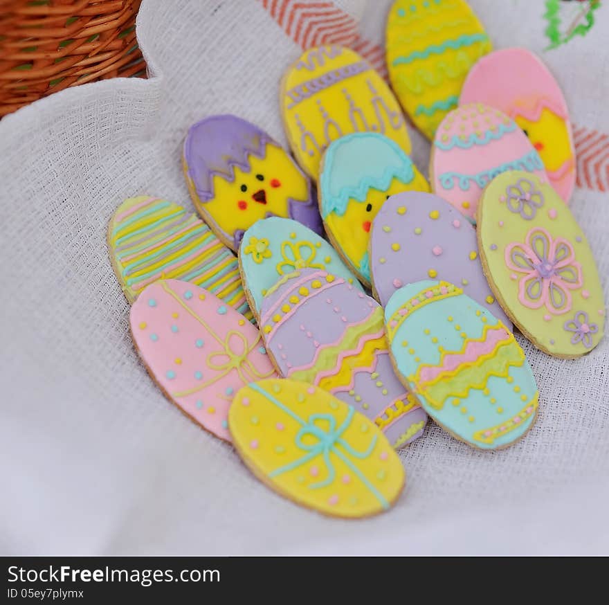 In basket on linen towel cookies in the form of Easter eggs