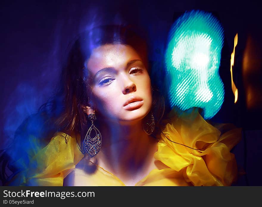 Motion. Stylized Woman in Radiant Abstract Lights. Illusion