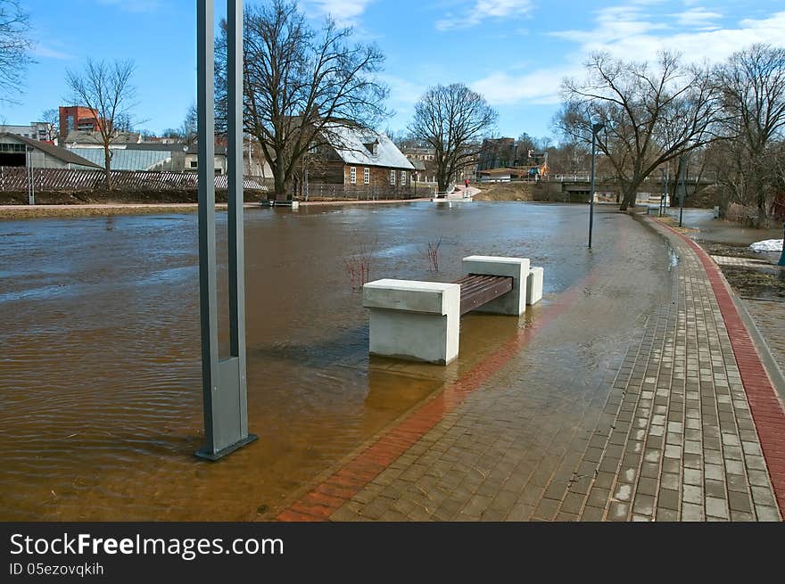 Urban river embankment submerged by flood