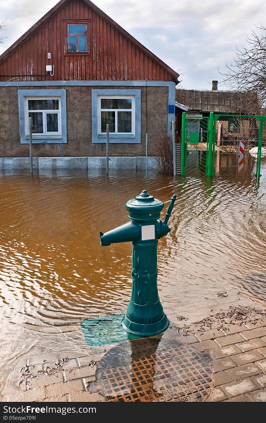 Flooding of urban river drowned house and street hydrant