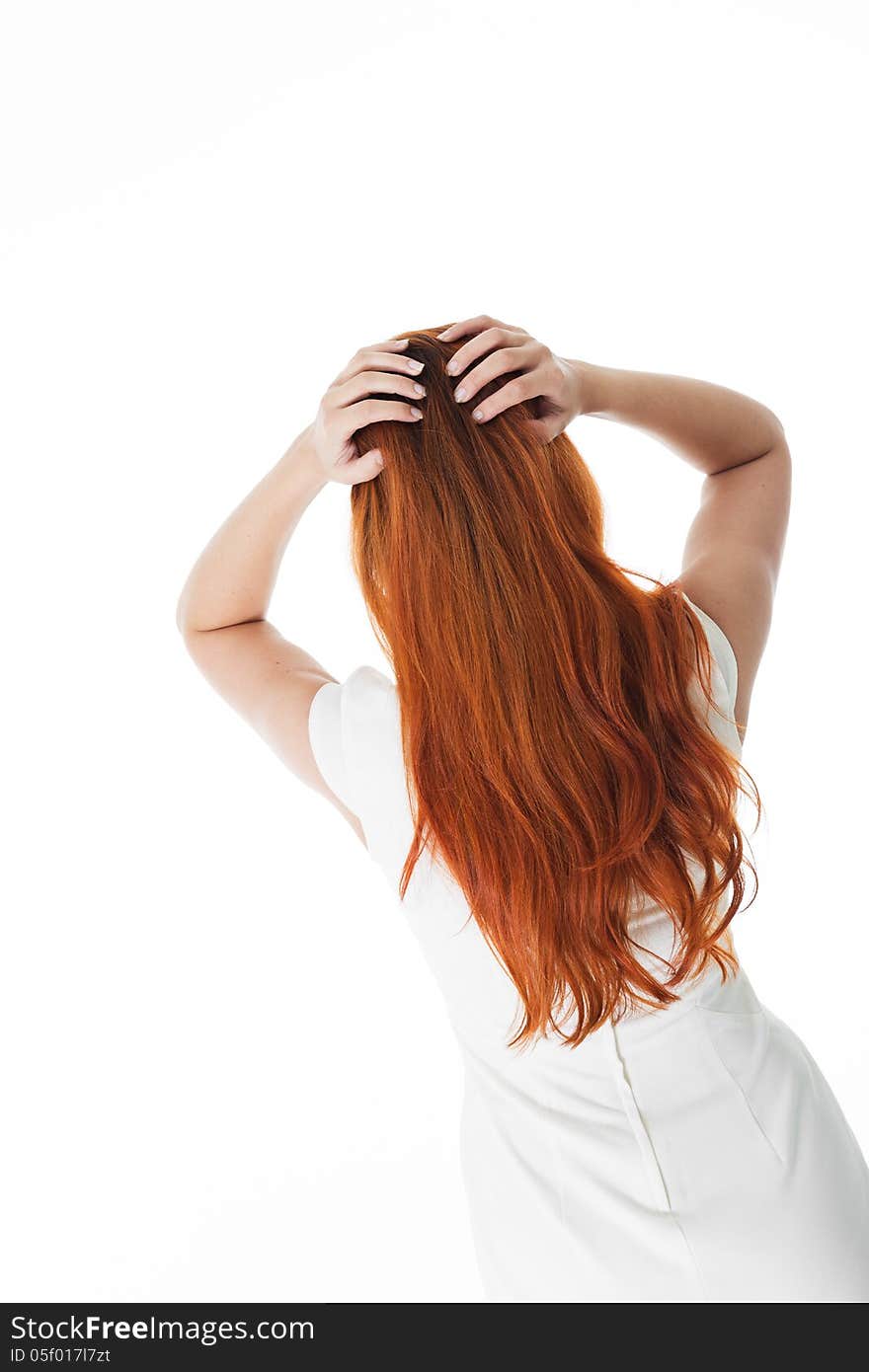 Rear view of a woman with long red hair wearing a simple white dress, isolated on white