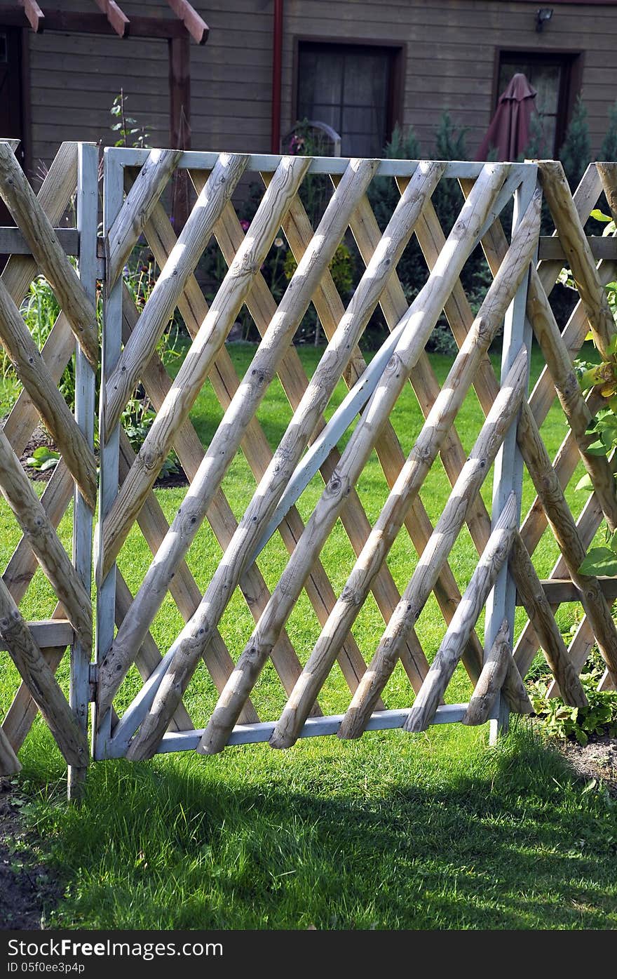 Closed wooden gate and fence in yard