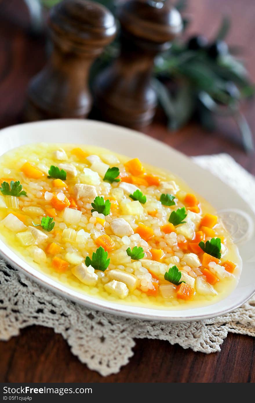 Soup with chicken, rice and vegetables, selective focus