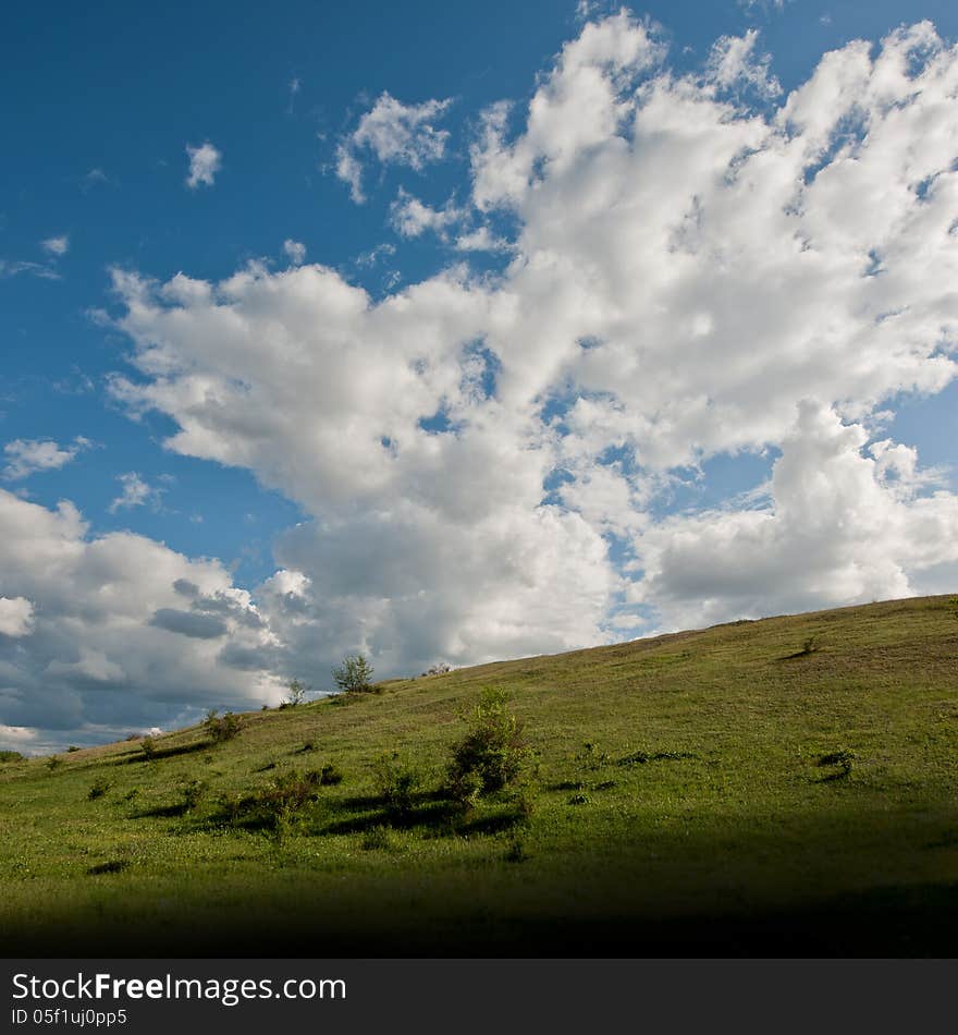 Spring landscape with clouds in the sky in a sunny day. Spring landscape with clouds in the sky in a sunny day