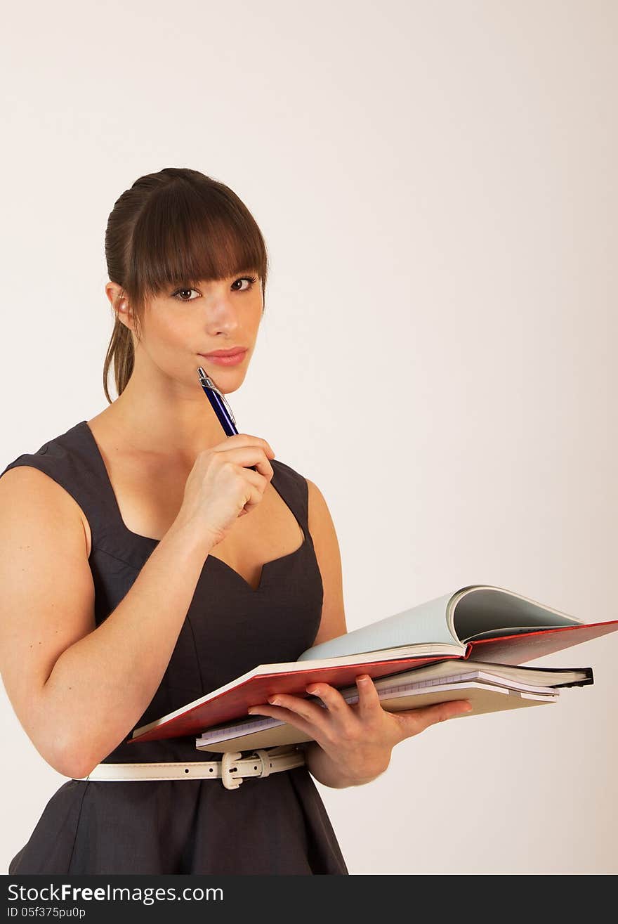 Young attractive female office worker taking notes