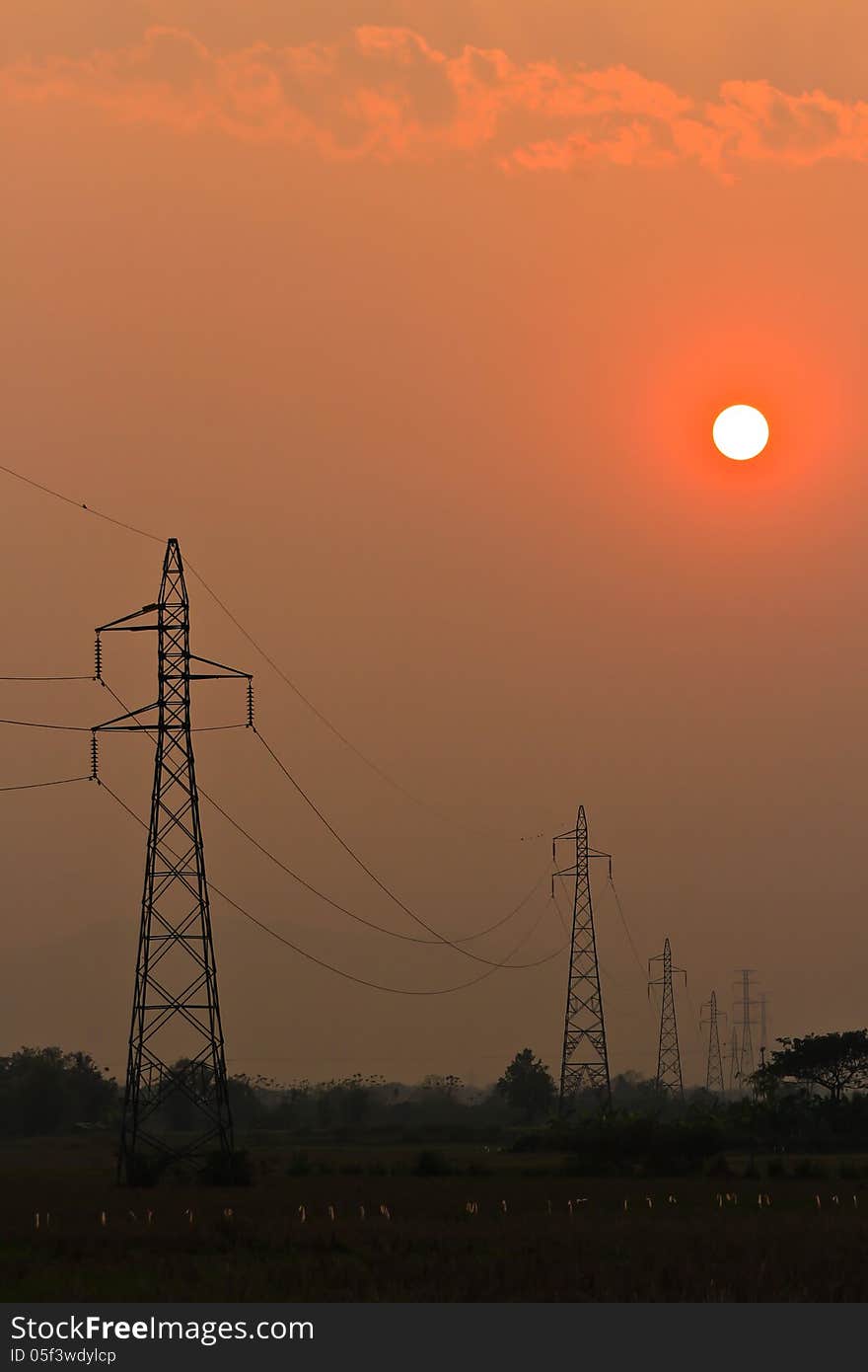 Electricity Pillars against a colorful yellow sunset