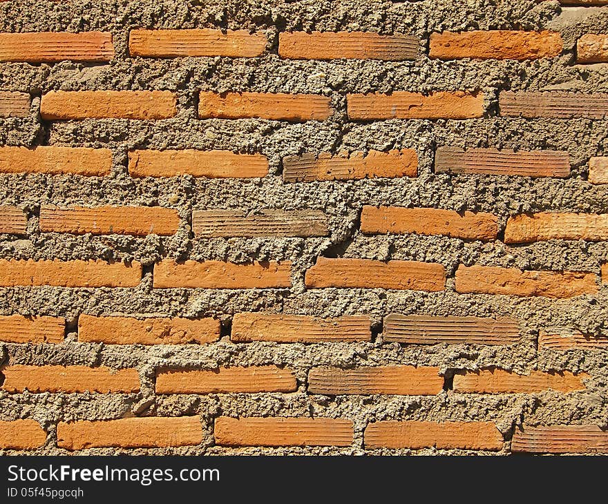 Pattern of brick and concrete wall in sunlight