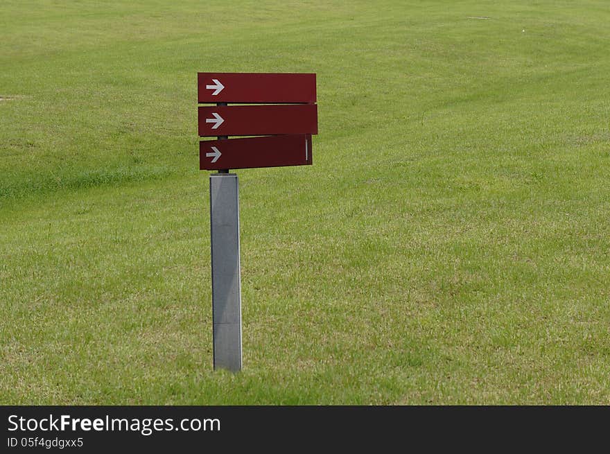 Blank sign with arrow in grassland. Blank sign with arrow in grassland