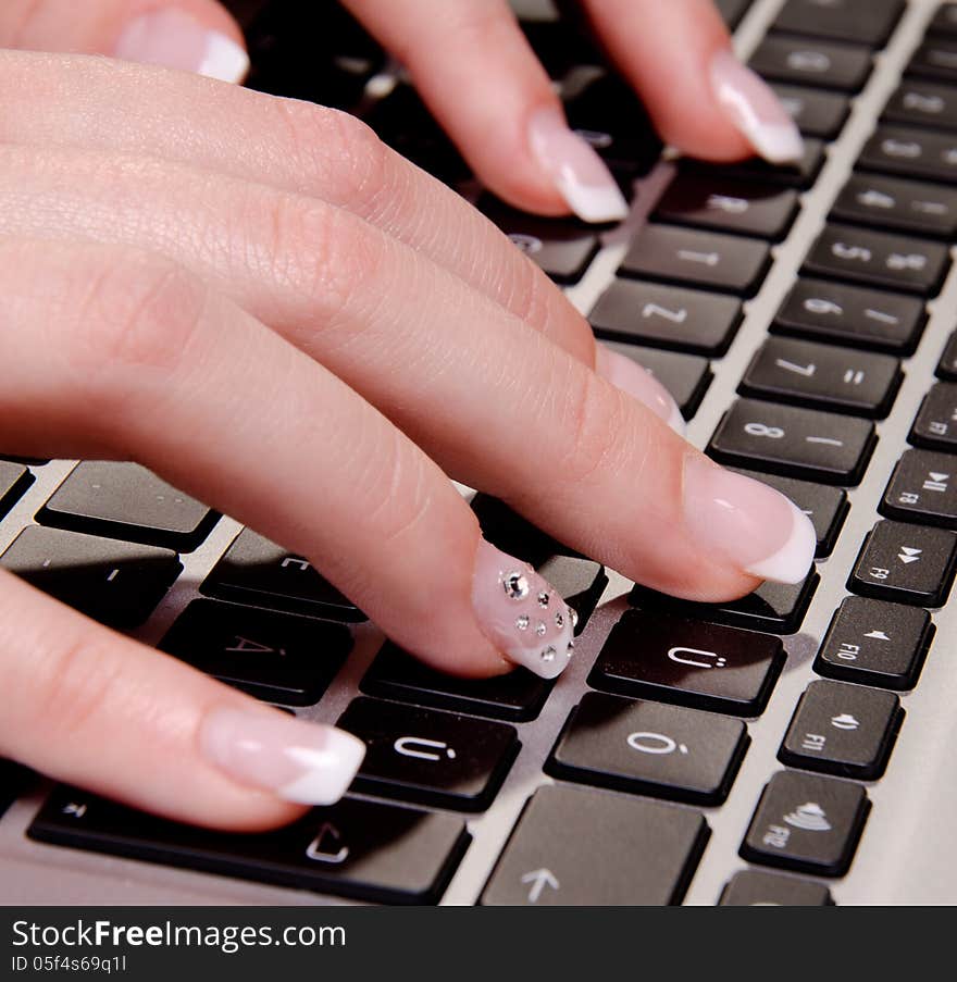 Woman is typing on a laptop