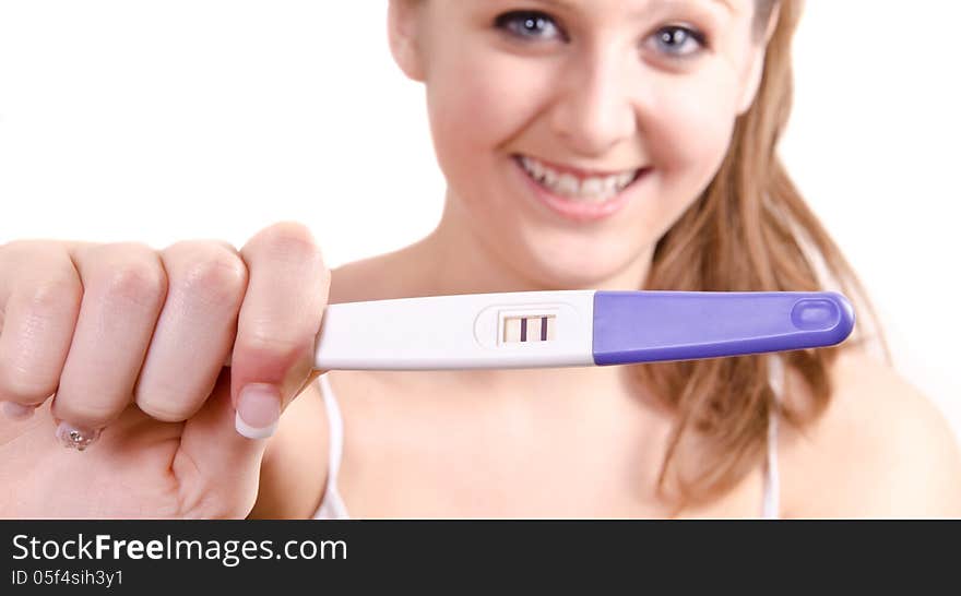 Cute girl is showing her positive pregnancy test.