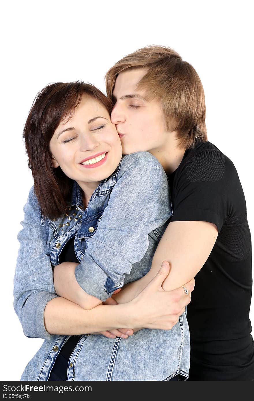 Young caucasian lovely couple kissing with closed eyes on white background