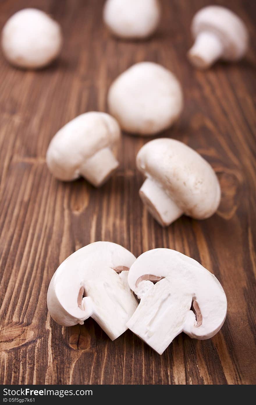 Sliced champignons on a wooden background, selective focus