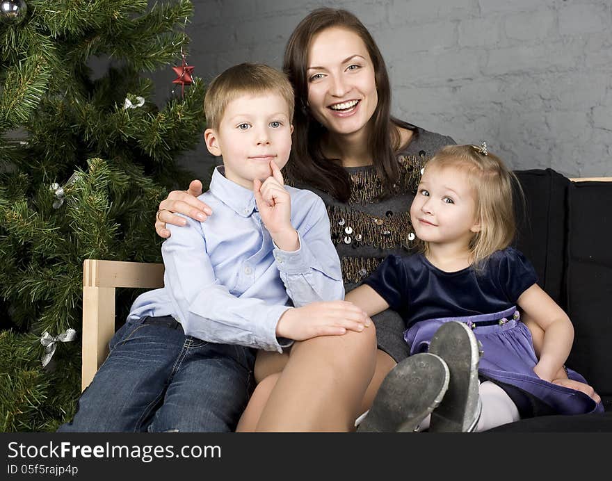 Happy family at Christmas tree hugging