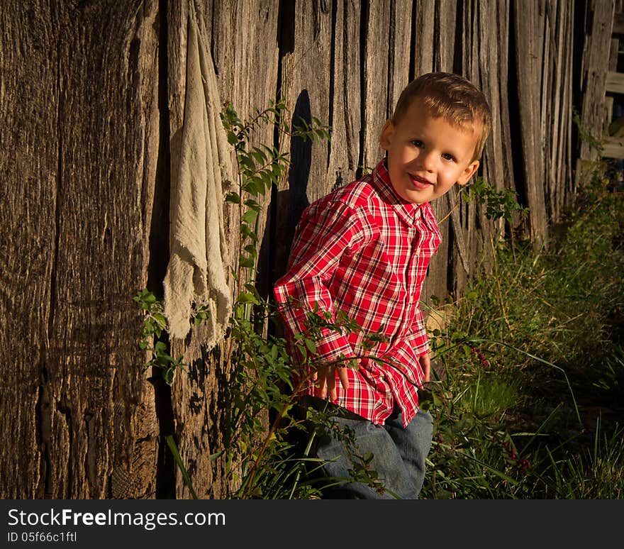 Young Farmer Next To Barn