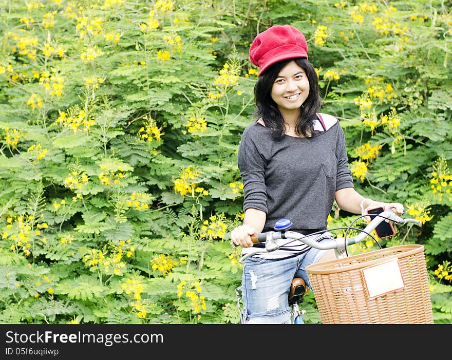 Portrait of an happy smiling girl riding a bicycle in the park.