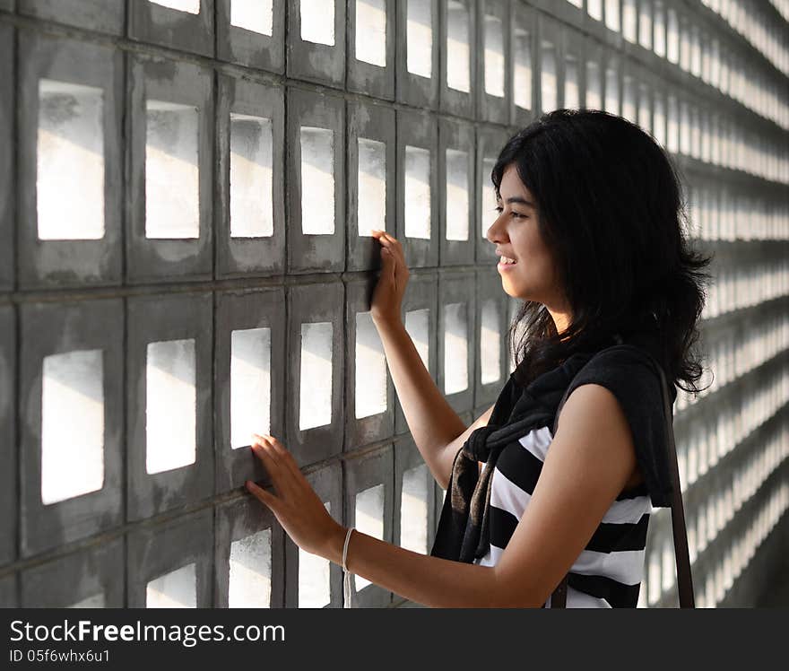 Beautiful hispanic woman with a sad expression on a dramatic background