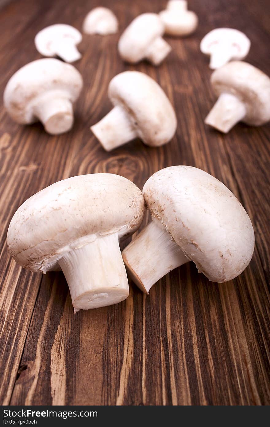 Champignons on a wooden background, selective focus