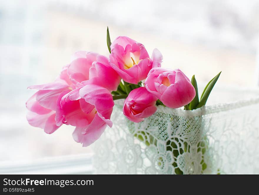 Still life with beautiful pink flowers in a lace decorative box closeup. Still life with beautiful pink flowers in a lace decorative box closeup