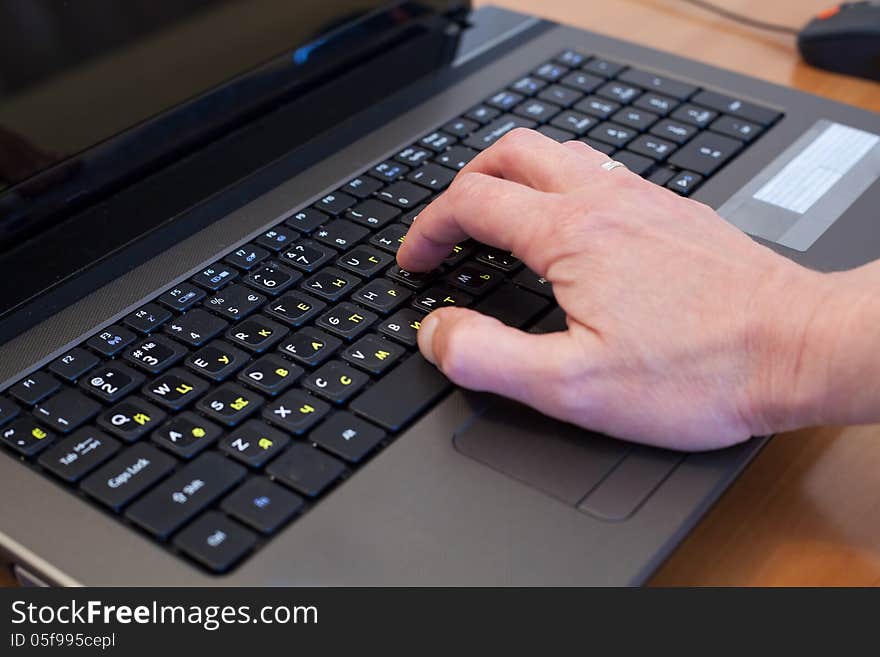 Man's hand on a black computer keyboard. Man's hand on a black computer keyboard