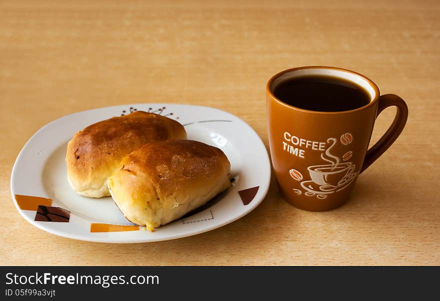 Cup of hot coffee and a plate of cakes on the table. Cup of hot coffee and a plate of cakes on the table