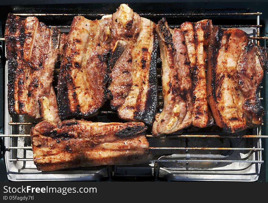 Pork spareribs toasting on barbecue. Pork spareribs toasting on barbecue