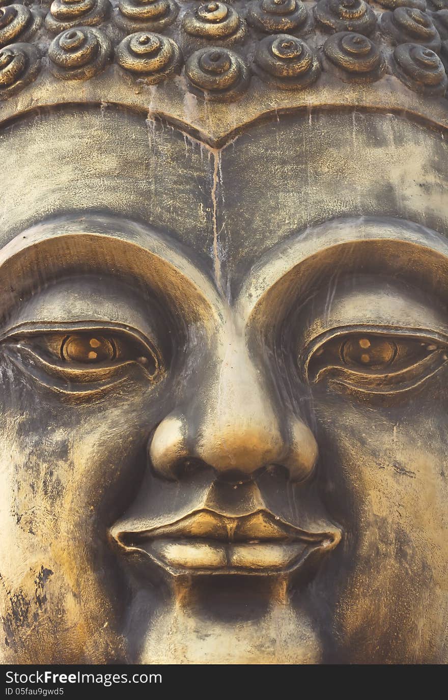 Close-up image of Buddha carved face full. Close-up image of Buddha carved face full.