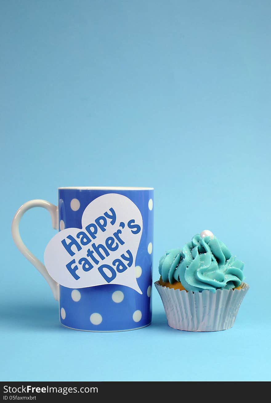 Happy Fathers Day special treat blue and white beautiful decorated cupcakes with message on blue background, with blue polka dot coffee mug. ertical with copy space for your text here. Happy Fathers Day special treat blue and white beautiful decorated cupcakes with message on blue background, with blue polka dot coffee mug. ertical with copy space for your text here.