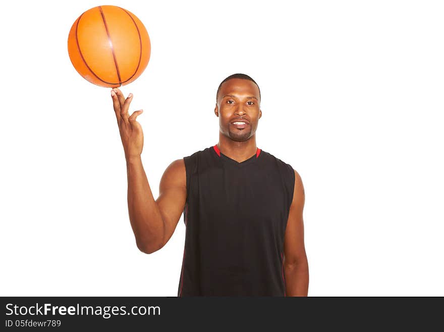 Portrait of a happy young basketball player spinning ball on finger isolated on white. waist up, horizontal shot. Portrait of a happy young basketball player spinning ball on finger isolated on white. waist up, horizontal shot.