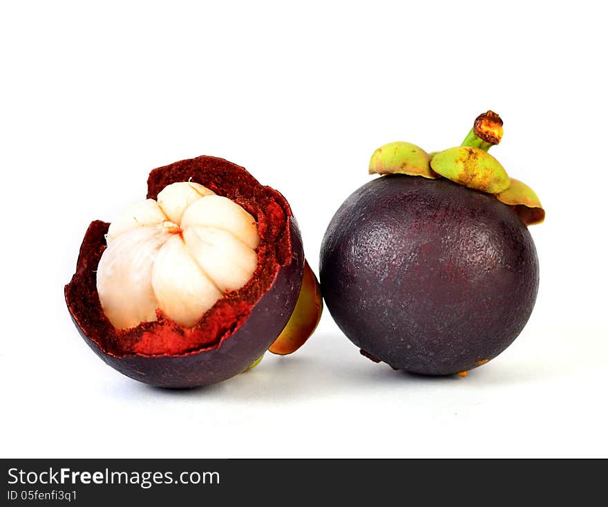 Mangosteen fruits and cross section showing the thick purple skin