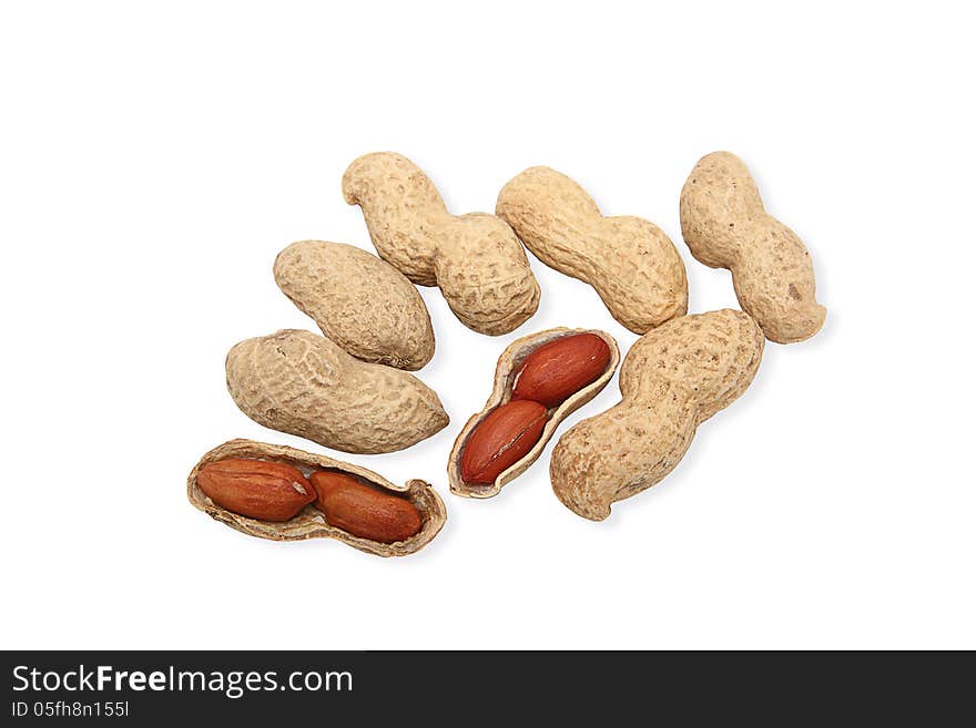 Image of groundnuts isolated on white background; two nuts are cracked open, showing reddish brown seeds. Clipping path included.