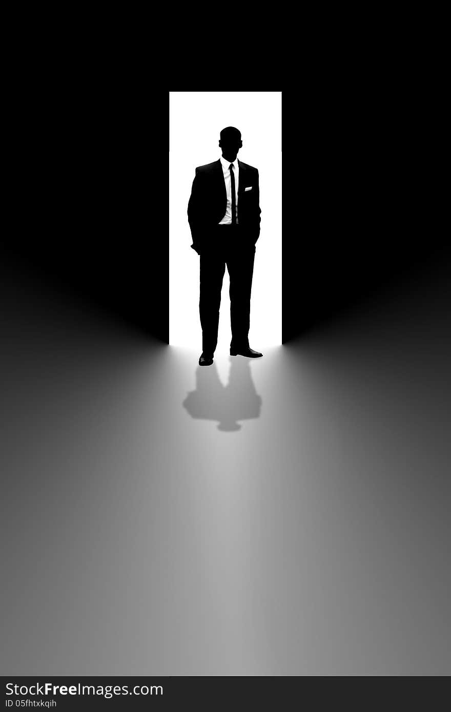 Silhouette of a businessman in a suit and tie standing in an open doorway. Silhouette of a businessman in a suit and tie standing in an open doorway.