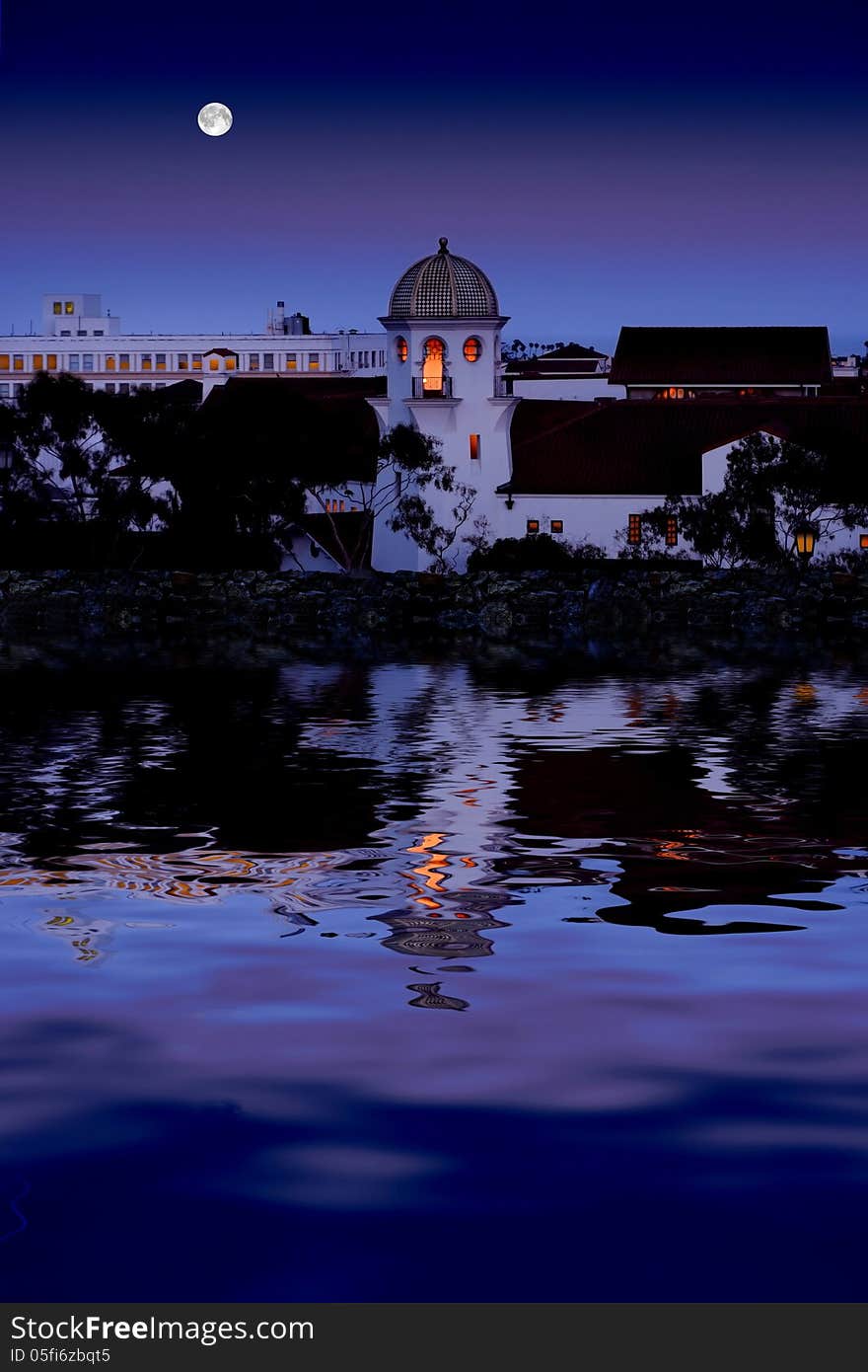 Beautiful old city reflecting in clam water with full moon