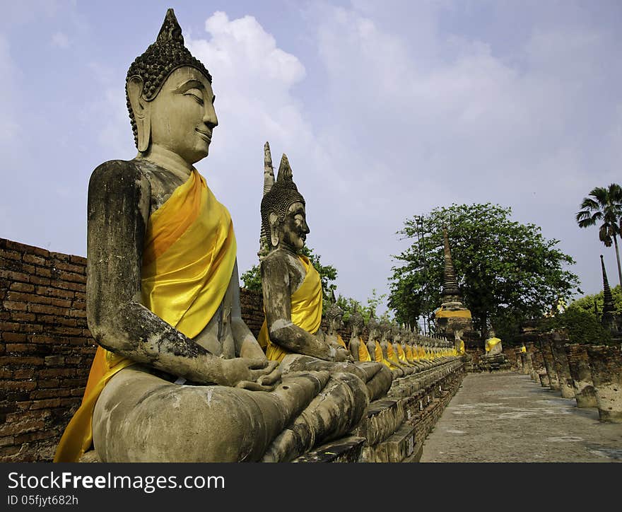 Buddha statues in a row at Wat Yai-Chaimongkol, Buddhist temple in Ayutthaya - Thailand