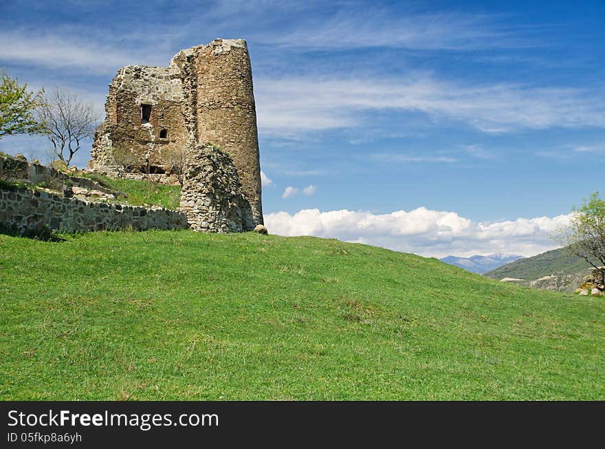 Ruin of medieval fortress sitting on grassy hill. Georgia. Ruin of medieval fortress sitting on grassy hill. Georgia