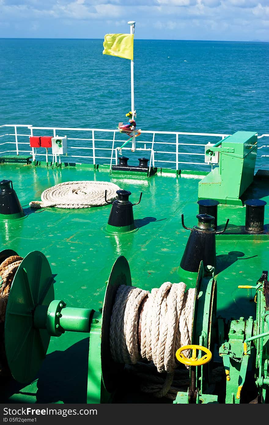 Traveling by sea on ferry boat. Blue sea landscape with sky. View from ship deck with ropes and flag