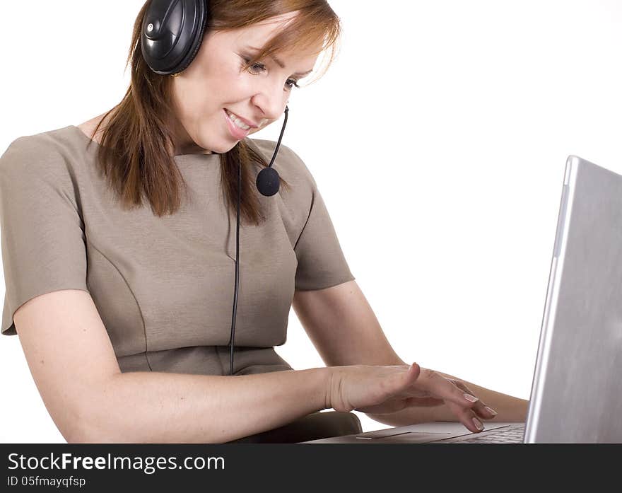 Portrait Of Pretty Call Operator Smiling And Typing On Lap Top