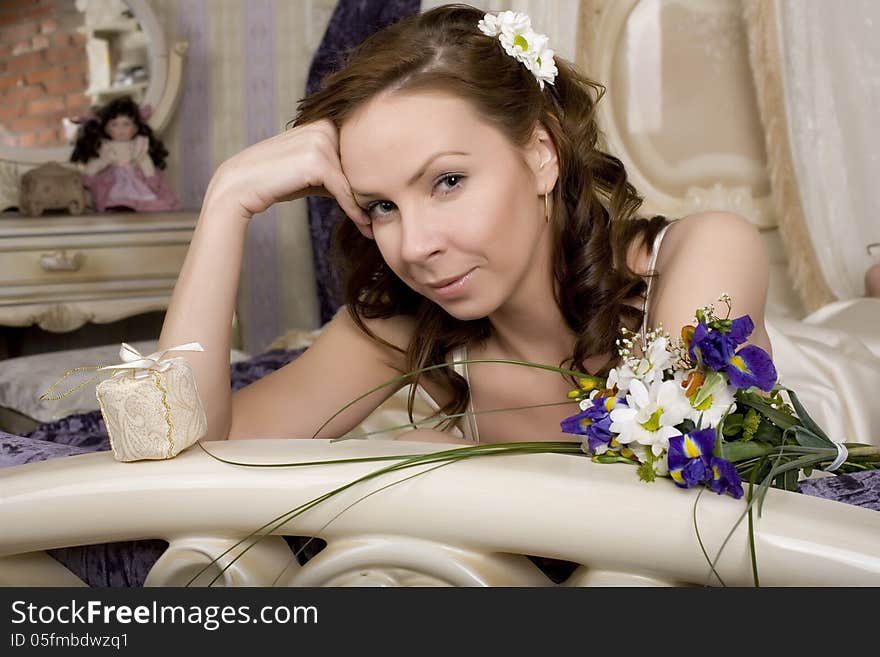 Woman with flowers in bed