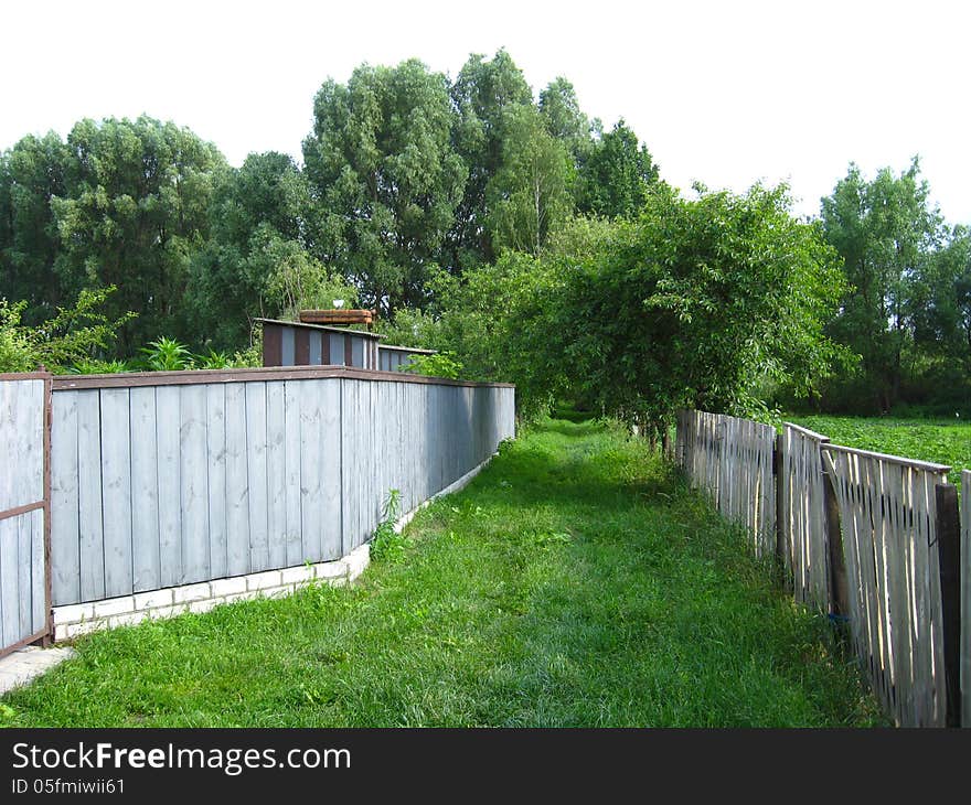 Fence And Little Street In Rural Manor