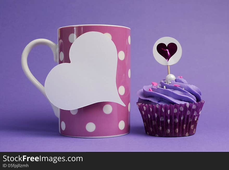 Mauve purple decorated cupcakes for children or teens birthday, or bachelorette, bridal or baby shower party function, with pink polka dot coffee mug and heart gift tag with copy space for your text here. Mauve purple decorated cupcakes for children or teens birthday, or bachelorette, bridal or baby shower party function, with pink polka dot coffee mug and heart gift tag with copy space for your text here.