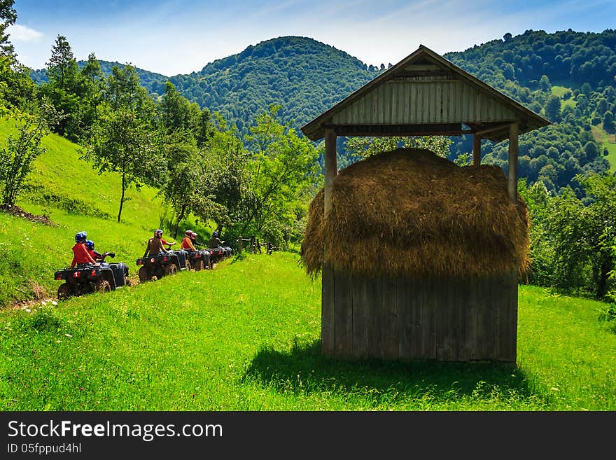 Bikers On ATVs On A Mountain Walk