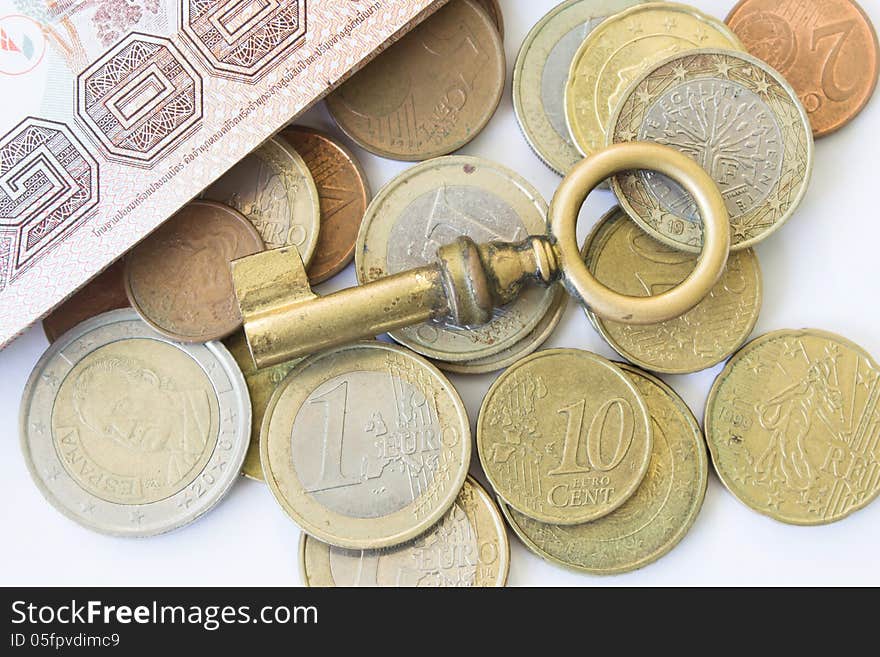 Old Key On Euro Coins Money For Financial Concept Background. Old Key On Euro Coins Money For Financial Concept Background