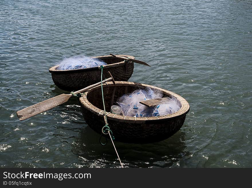 Coracles with fishing nets floating on the water