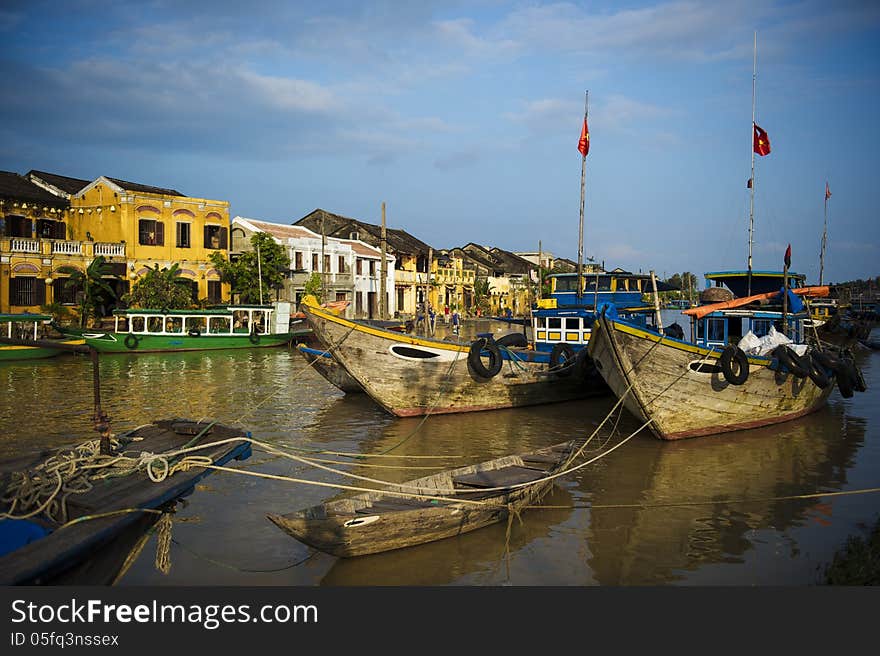 Ancient town viewed from the river with fisfingboats at foreground