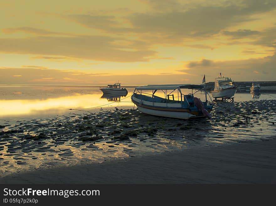 Motorboats on the beach of Nusa Dua at sunrise