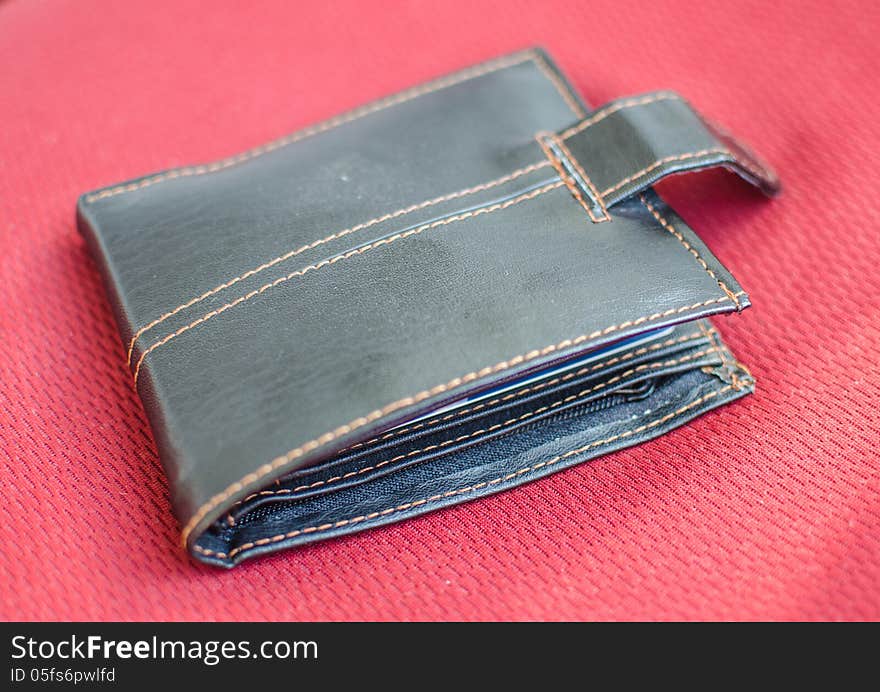 Brown wallet on red background